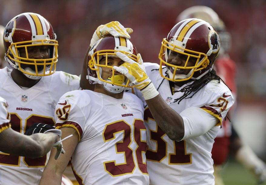 Washington Redskins cornerback Greg Ducre (38) celebrates after intercepting a pass with cornerback Bashaud Breeland, left, and strong safety Brandon Meriweather (31) against the San Francisco 49ers during the third quarter of an NFL football game in Santa Clara, Calif., Sunday, Nov. 23, 2014. (AP Photo/Ben Margot)