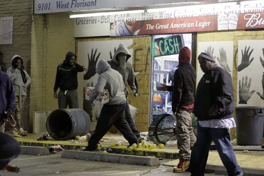 Ferguson Market and Liquor store is vandalized after the announcement of the grand jury decision Monday, Nov. 24, 2014, in Ferguson, Mo. A grand jury has decided not to indict Ferguson police officer Darren Wilson in the death of Michael Brown, the unarmed, black 18-year-old whose fatal shooting sparked sometimes violent protests. (AP Photo/Jeff Roberson)