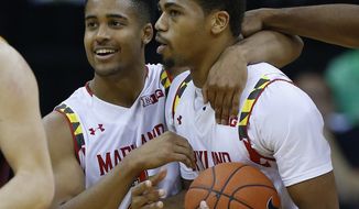 Maryland guard Melo Trimble (left) hugs Richaud Pack after Pack was fouled in the final minutes in the second half of the CBE Hall of Fame Classic game against Arizona State on Monday in Kansas City, Mo. Maryland won 78-73. (Associated Press)