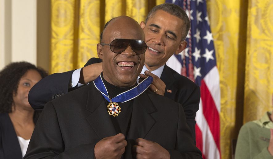 Musician Stevie Wonder celebrates as President Barack Obama awards him the Presidential Medal of Freedom, Monday, Nov. 24, 2014, during a ceremony in the East Room of the White House in Washington.  President Obama is presenting the nation&#39;s highest civilian honor to 19 artists, activists, public servants and others.  (AP Photo/Jacquelyn Martin)