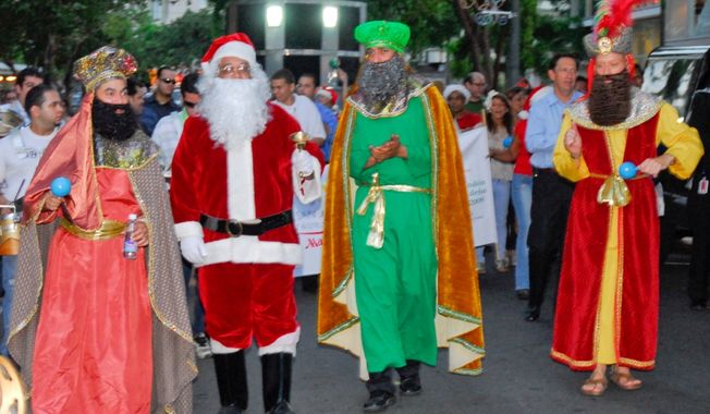 Actors dressed as Santa Claus and the Three Kings walk during a parranda in Puerto Rico. Image courtesy San Juan Marriott.