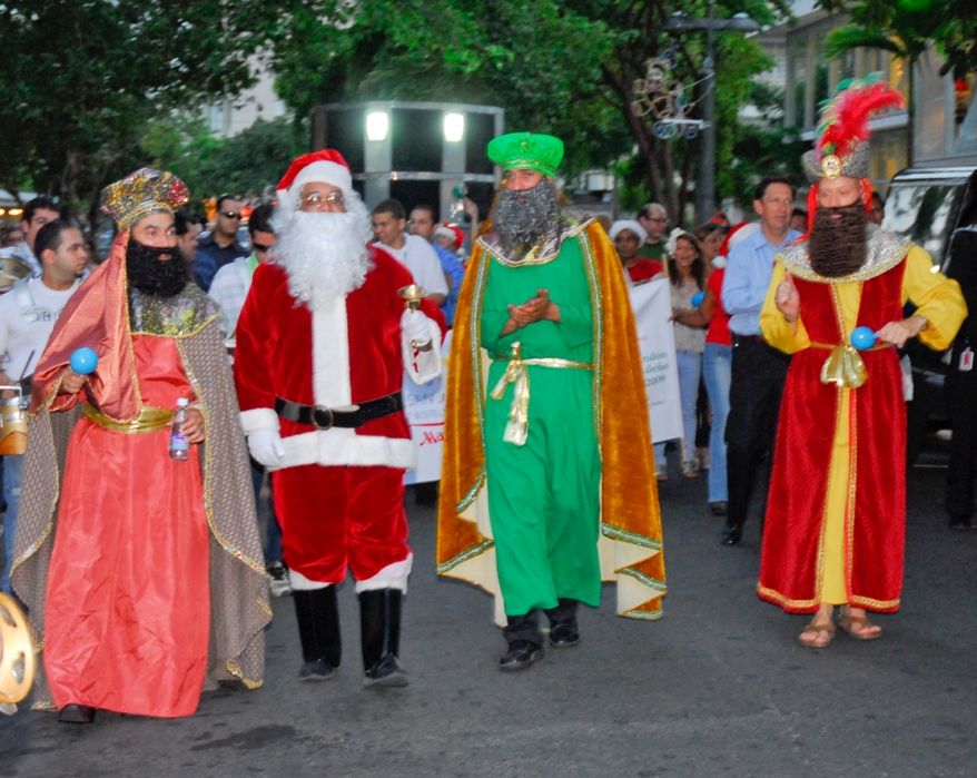Actors dressed as Santa Claus and the Three Kings walk during a parranda in Puerto Rico. Image courtesy San Juan Marriott.