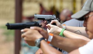 In this July 20, 2014, photo, shooters practice with pistols at the gun range at Dragonman&#39;s, a gun dealer east of Colorado Springs, Colo. (AP Photo/Brennan Linsley) ** FILE **