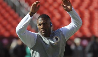 Washington Redskins free safety Ryan Clark (25) works during warm ups before an NFL football game against the Tennessee Titans, Sunday, Oct. 19, 2014, in Landover, Md. (AP Photo/Richard Lipski)
