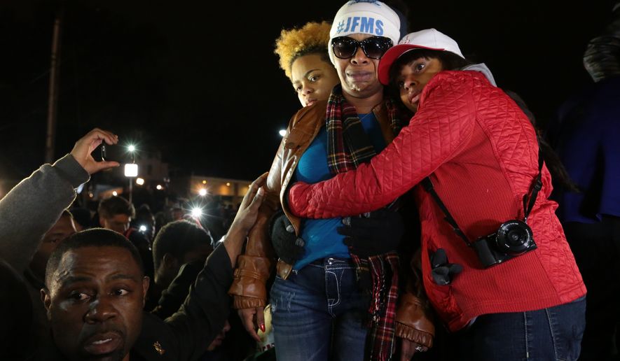 Lesley McSpadden, second from right, Michael Brown&#39;s mother, is comforted outside the Ferguson police department as St. Louis County Prosecutor Robert McCulloch conveys the grand jury&#39;s decision not to indict Ferguson police officer Darren Wilson in the shooting death of her son, Monday, Nov. 24, 2014, in Ferguson, Mo. (AP Photo/St. Louis Post-Dispatch, Robert Cohen)  **FILE**