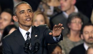 President Obama tries to quiet one of three hecklers as he addresses the crowd after meeting with community leaders about the executive actions he is taking to fix the immigration system Tuesday, Nov. 25, in Chicago. (Associated Press)