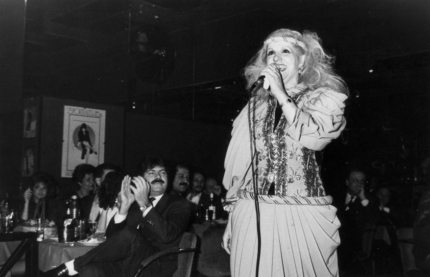 In this 1987 photo, Lebanese singer and actress Sabah whose real name is Jeanette Feghali, an icon of Arab music, sings during a performance at a Lebanese restaurant, in Beirut. Sabah, died Wednesday, Nov. 26, 2014 morning at age 87, the Lebanese National News Agency reported, without offering a cause of death. Her health had been declining in recent years. (AP Photo/Stavro Jabra)