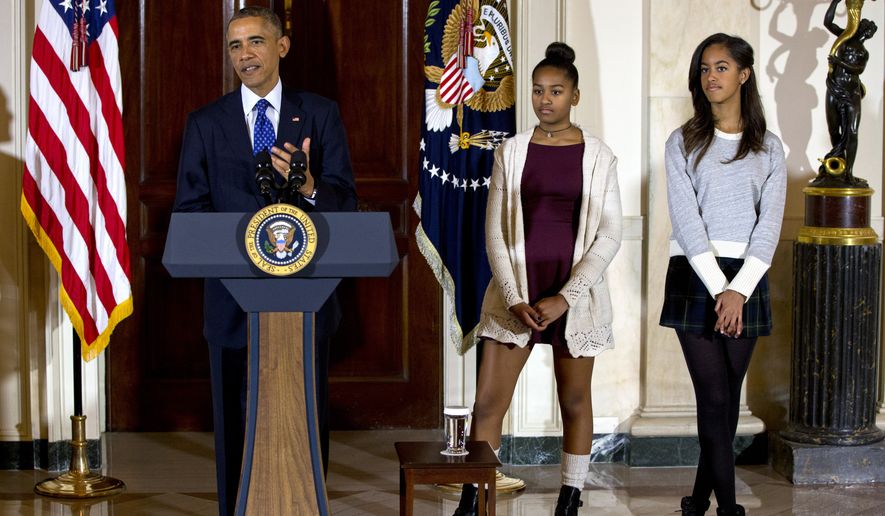 President Barack Obama, joined by his daughters Malia, right, and Sasha, center, speaks at the White House, in Washington, Wednesday, Nov. 26, 2014, during the presidential turkey pardon ceremony, an annual Thanksgiving tradition. (AP Photo/Jacquelyn Martin)