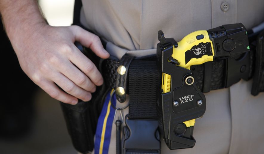 A Taser X26 stun gun is seen on a California Highway Patrol&#x27;s belt. A 2011 Justice Department study on the use of Tasers and other nonlethal weapons concluded they can spare lives and injury for both suspects and officers. (Associated Press) **FILE**