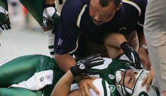 FILE - In this Sunday, Nov. 6, 2005, file photo, New York Jets&#39; Wayne Chrebet lies unconscious while a San Diego Chargers trainer looks over him after he took a hit on a reception during the fourth quarter of an NFL football game, in East Rutherford, N.J. Chrebet sustained a season-ending concussion on the play. Chrebet suffered at least six or seven concussions during his career. At halftime of the Jets&#39; game against Miami, on Monday, Dec. 1, 2014, Chrebet will be inducted into the team&#39;s Ring of Honor along with late former owner Leon Hess. (AP Photo/Tim Larsen, File)