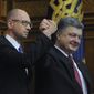Ukraine&#39;s President Petro Poroshenko, right, celebrates with Arseniy Yatsenyuk after Yatsenyuk was appointed as Prime Minister during the opening first session of the Ukrainian parliament in Kiev, Ukraine, Thursday, Nov. 27, 2014. Parliament in Ukraine has opened for its first session since an election last month that ushered in a spate of pro-Western parties. (AP Photo/Andrew Kravchenko, Pool)