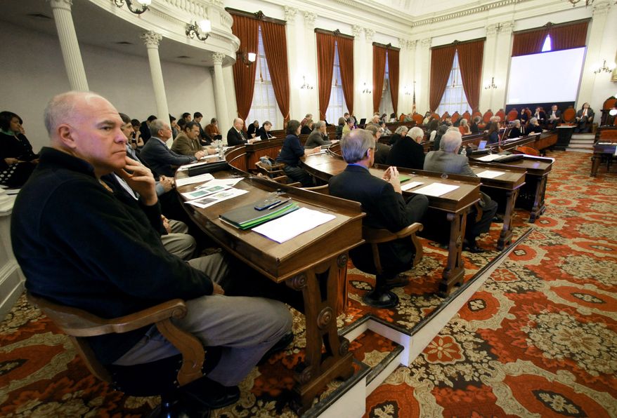 Sen. Joe Benning, left, R-Caledonia, listens during a legislative gathering at the Statehouse on Wednesday, Nov. 20, 2013 in Montpelier, Vt. Growing numbers of pre-trial detainees in Vermont prisons and paying sheriffs to monitor mentally ill patients in hospital emergency rooms are among the many budget pressures facing Vermont state government. The administration of Gov. Peter Shumlin briefed lawmakers on the budget challenges they're expected to face when they return in January.(AP Photo/Toby Talbot)