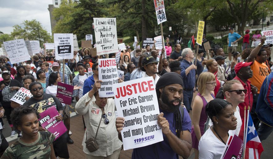 FILE - Demonstrators march to protest the death of Eric Garner, Saturday, Aug. 23, 2014, in the Staten Island borough of New York. Amid the fallout from a grand jury&#x27;s decision in the fatal police shooting of Michael Brown in Missouri, a panel in New York City is quietly nearing its own conclusion about another combustible case involving the death of an unarmed man at the hands of police. (AP Photo/John Minchillo, File)