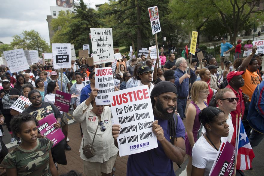 FILE - Demonstrators march to protest the death of Eric Garner, Saturday, Aug. 23, 2014, in the Staten Island borough of New York. Amid the fallout from a grand jury&#39;s decision in the fatal police shooting of Michael Brown in Missouri, a panel in New York City is quietly nearing its own conclusion about another combustible case involving the death of an unarmed man at the hands of police. (AP Photo/John Minchillo, File)