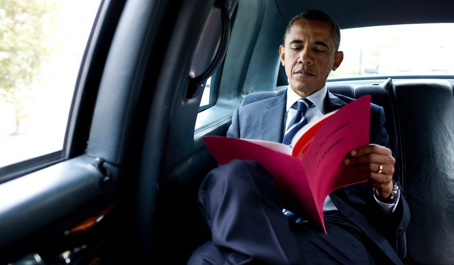 President Barack Obama reads a document while en route to Pittsburgh International Airport in Pittsburgh, Pa., Oct. 11, 2011. (Official White House Photo by Pete Souza)