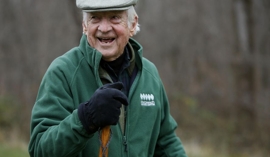 In this photo taken on Nov. 12, 2014, John A. Ruthven hikes on his 165-acre property, in Georgetown, Ohio. Each morning he hikes for about an hour and a half, covering 4 miles. Ruthven, a wildlife artist who turned 90 on Wednesday, Nov. 26, 2014, uses many of the scenes he's encountered on his hikes as backdrops for his paintings. (AP Photo/The Cincinnati Enquirer, Carrie Cochran) MANDATORY CREDIT; NO SALES
