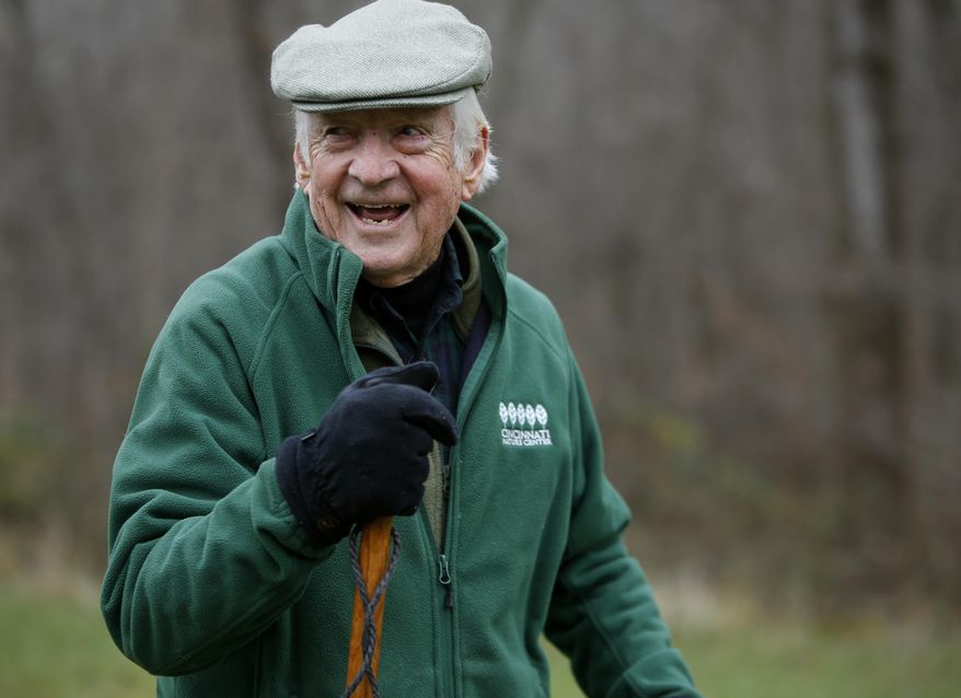 In this photo taken on Nov. 12, 2014, John A. Ruthven hikes on his 165-acre property, in Georgetown, Ohio. Each morning he hikes for about an hour and a half, covering 4 miles. Ruthven, a wildlife artist who turned 90 on Wednesday, Nov. 26, 2014, uses many of the scenes he's encountered on his hikes as backdrops for his paintings. (AP Photo/The Cincinnati Enquirer, Carrie Cochran) MANDATORY CREDIT; NO SALES