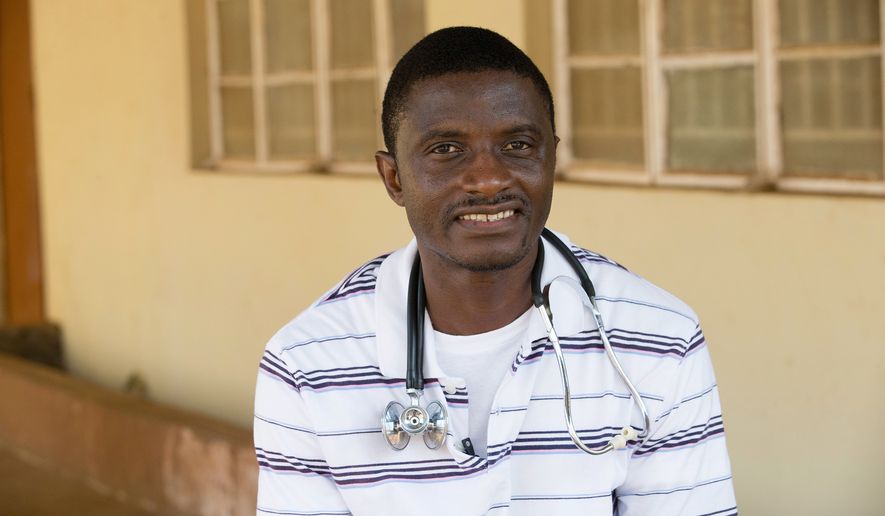 In this April 2014, file photo, provided by the United Methodist News Service, Dr. Martin Salia poses for a photo at the United Methodist Church&#39;s Kissy Hospital outside Freetown, Sierra Leone. Salia, who died of Ebola after treating patients in his native Sierra Leone, will be remembered in the suburbs of Washington, where his family lives. (AP Photo/United Methodist News Service, Mike DuBose, File)
