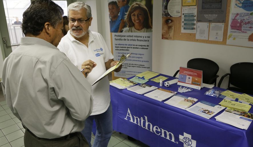 In this Oct. 1, 2013, file photo, Alberto Pizon, right, a representative of Anthem BlueCross BlueShield Latino Health Access group provides free information to Paulino Zarate, 65, left, on the new health options available during a health fair promoted at the Binational Health Week event held at the Mexican Consulate in Los Angeles. (AP Photo/Damian Dovarganes, File)