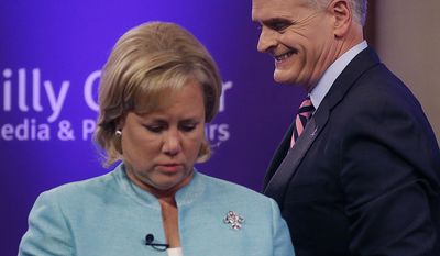 Sen. Mary Landrieu, D-La., and Rep. Bill Cassidy, R-La., take their places to participate in a Senate race debate with and Republican candidate and Tea Party favorite Rob Maness, not pictured,  on the LSU campus in Baton Rouge, La., Wednesday, Oct. 29, 2014. (AP Photo/Gerald Herbert)