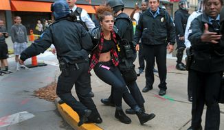 Police arrest a protester on Sunday, Nov. 30, 2014, at Kiener Plaza, in St. Louis. Protesters and police clashed following an NFL football game between the St. Louis Rams and the Oakland Raiders as protests continued following a grand jury&#39;s decision not to indict a Ferguson police officer in the shooting death of Michael Brown.  (AP Photo/St. Louis Post-Dispatch, Laurie Skrivan)