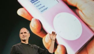 Apple CEO Steve Jobs speaks during a launch event for Apple&#x27;s music download service, iTunes, in Tokyo in this Aug. 4, 2005, file photo. A billion-dollar class-action lawsuit over Apple’s iPod music players heads to trial in a California federal court Tuesday, Dec. 2, 2014, in an antitrust case where the legal wrangling has lasted far longer than the technology that sparked the complaint. (AP Photo/Shizuo Kambayashi, File)