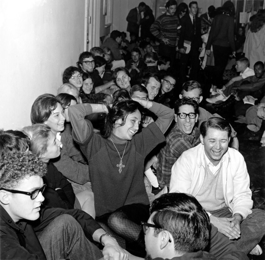 In this Dec. 2, 1964, file photo, folk singer Joan Baez clowns as she sits with student demonstrators in Sproul Hall on the University of California campus in Berkeley, Calif. The students, participating in a Free Speech Movement, will remain until disciplinary action is dropped against four self-styled free speech leaders. This fall marks the 50th anniversary of the Free Speech Movement, a protest that only lasted for three months but set the stage for the turbulent 1960s. (AP Photo, File)