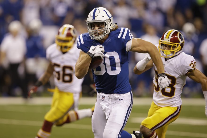 Indianapolis Colts tight end Coby Fleener heads for a touchdown during the second half of an NFL football game against the Washington Redskins Sunday, Nov. 30, 2014, in Indianapolis. (AP Photo/Darron Cummings)