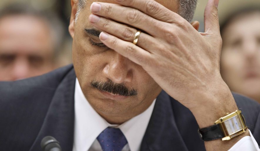 Attorney General Eric H. Holder Jr. puts his hand to his face while testifying on Capitol Hill in Washington on Thursday, Feb. 2, 2012. Associated Press photo.