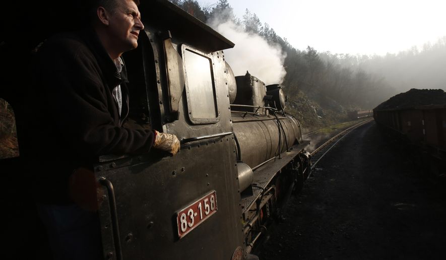 Bosnian worker Sefik Salihovic drives a steam engine in the Bosnian town of Banovici, 140 kms (86.9 miles) north of Sarajevo, on Monday, Nov. 24, 2014. Every day, steam engines over 60 years old, defy their age and still pull wagons of coal from Banovici's coal mine to clients in nearby towns. But in the summer some of them turn into the only tourist attraction this impoverished north Bosnian town has to offer. (AP Photo/Amel Emric)