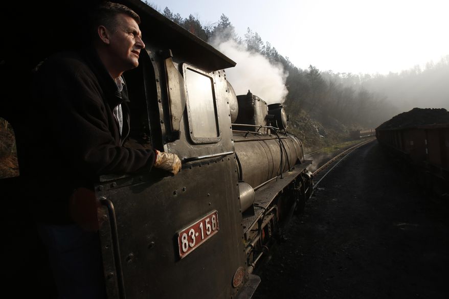 Bosnian worker Sefik Salihovic drives a steam engine in the Bosnian town of Banovici, 140 kms (86.9 miles) north of Sarajevo, on Monday, Nov. 24, 2014. Every day, steam engines over 60 years old, defy their age and still pull wagons of coal from Banovici's coal mine to clients in nearby towns. But in the summer some of them turn into the only tourist attraction this impoverished north Bosnian town has to offer. (AP Photo/Amel Emric)