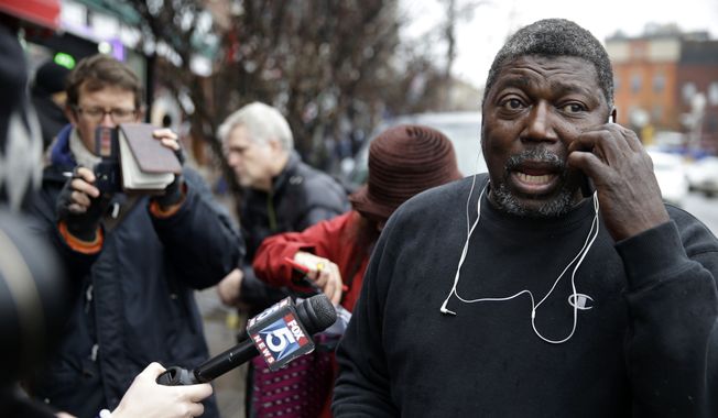 Benjamin Carr, stepfather of Eric Garner, talks on the phone and to reporters after a grand jury&#x27;s decision not to indict a New York police officer involved in Garner&#x27;s death, Wednesday, Dec. 3, 2014, in the Staten Island borough of New York. The decision not to indict Officer Daniel Pantaleo added to the tensions that have simmered in the city since Garner&#x27;s death on July 17. (AP Photo/Seth Wenig)