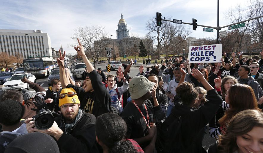 East High School students in Denver participate in a protest against the Ferguson, Missouri grand jury decision, in a busy intersection in front of the state Capitol, Wednesday Dec. 3, 2014. (AP Photo/Brennan Linsley) **FILE**