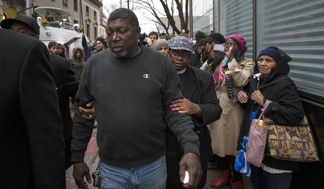 Benjamin Carr, relative of Eric Garner, leaves the district attorney&#x27;s office after a grand jury&#x27;s decision not to indict a New York police officer involved in the death of Garner, Wednesday, Dec. 3, 2014, in the Staten Island borough of New York.  A video shot by an onlooker and widely viewed on the Internet showed the 43-year-old Garner telling a group of police officers to leave him alone as they tried to arrest him. The city medical examiner ruled Garner&#x27;s death a homicide and found that a chokehold contributed to it. (AP Photo/John Minchillo)
