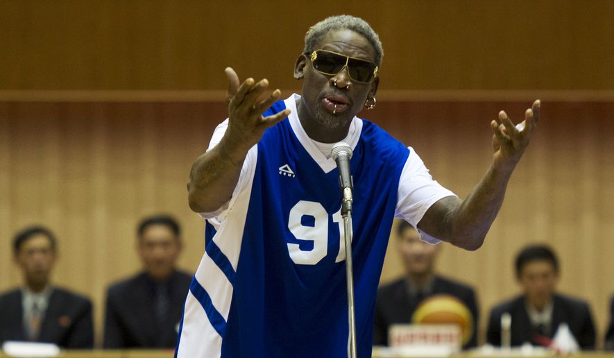 Dennis Rodman sings &quot;Happy Birthday&quot; to North Korean leader Kim Jong-un, seated above in the stands, before an exhibition basketball game at an indoor stadium in Pyongyang, North Korea on Wednesday, Jan. 8, 2014. (AP Photo/Kim Kwang Hyon, File)