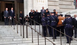 District officers carry the casket of former Mayor Marion Barry up the steps of the John A. Wilson Building, Thursday to be greeted by Mayor Vincent Gray and Council Chairman Phil Mendelson. Mr. Barry&#39;s remains were to lie in repose for 24 hours before a procession Friday to The Temple of Praise church. A viewing is scheduled Saturday at the convention center. (Associated Press)