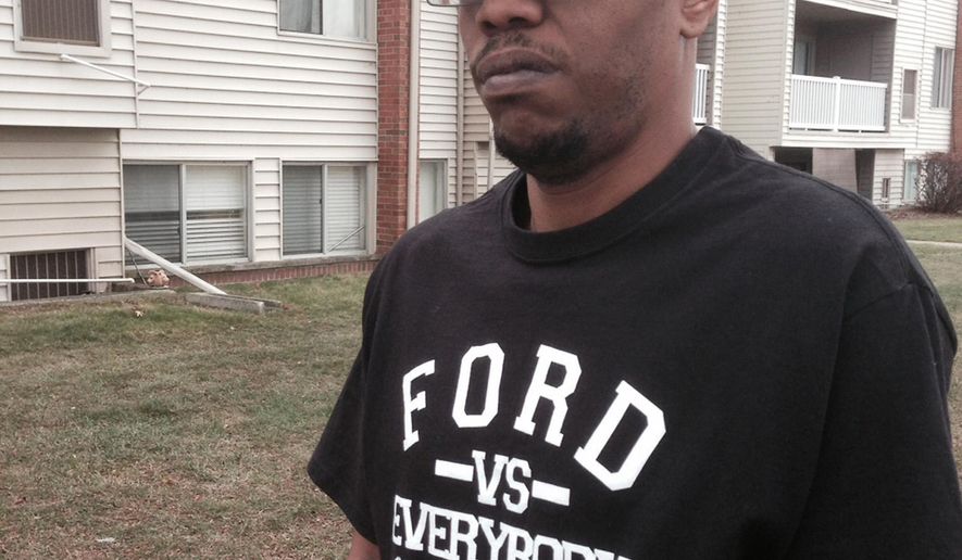 In a photo from Dec. 3, 2014, Tonocca Scott, 40, of Ypsilanti, Mich., stands outside his apartment building with prescription drugs for back pain. Scott blames Dr. Aria Sabit for a botched back surgery. The Detroit-area doctor is charged in federal court with fraud. He's accused of billing insurers for wrong procedures and misleading patients about how he planned to fix their spines. He surrendered his California medical license earlier this year. (AP Photo/Ed White)