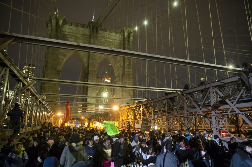 Demonstrators march across the Brooklyn Bridge during a protest against a grand jury's decision not to indict the police officer involved in the death of Eric Garner, Thursday, Dec. 4, 2014, in New York. A grand jury cleared a white New York City police officer Wednesday in the videotaped chokehold death of Garner, an unarmed black man, who had been stopped on suspicion of selling loose, untaxed cigarettes. (AP Photo/John Minchillo)
