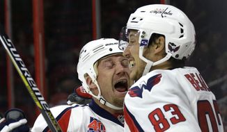 Washington Capitals&#39; Jason Chimera celebrates with Jay Beagle (83) following Beagle&#39;s goal against the Carolina Hurricanes during the first period of an NHL hockey game in Raleigh, N.C., Thursday, Dec. 4, 2014. (AP Photo/Gerry Broome)