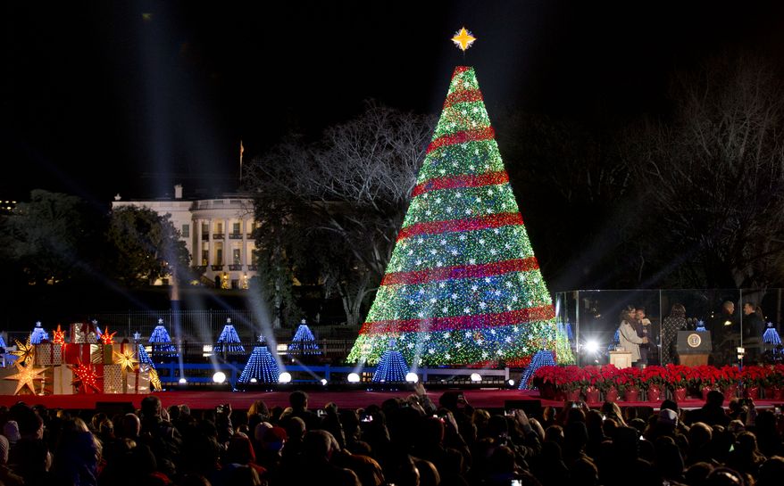 President Barack Obama and the first family stands, right, after lighting the 2014 National Christmas Tree during the National Christmas Tree lighting ceremony at the Ellipse near the White House in Washington, Thursday, Dec. 4, 2014. (AP Photo/Carolyn Kaster)