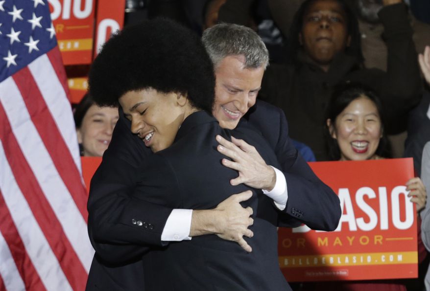 In this Nov. 5, 2013, file photo, Democratic Mayor-elect Bill de Blasio embraces his son Dante on stage after he was elected mayor of New York City in the Brooklyn borough of New York. As de Blasio spoke Wednesday, Dec. 3, 2014, in the aftermath of a grand jury&#x27;s decision not to indict a white police officer in the chokehold death of Eric Garner, he drew upon the experiences of his own family to connect with disheartened New Yorkers. (AP Photo/Kathy Willens)