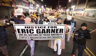 Hundreds of people march in the streets of Newark, N.J. to protest police brutality and the previous day&#39;s decision to not indict the New York City police officer involved in the death of Eric Garner in Staten Island on Thursday, Dec. 4, 2014. (AP Photo/The Record of Bergen County - Northjersey.com, Kevin R. Wexler)