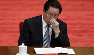 In this photo taken May 4, 2012, Zhou Yongkang, Chinese Communist Party Politburo Standing Committee member in charge of security, attends a conference to celebrate the 90th anniversary of the founding of Chinese Communist Youth League at the Great Hall of the People in Beijing. China&#39;s official Xinhua News Agency says the country&#39;s former security chief, Zhou Yongkang, has been expelled from the Communist Party. Xinhua said the decision was made Friday Dec. 5, 2014 at a meeting of the Political Bureau of the party&#39;s Central Committee. (AP Photo/Alexander F. Yuan, File)