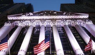 In this Wednesday, Oct. 8, 2014, photo, American flags fly in front of the New York Stock Exchange, in New York. (AP Photo/Mark Lennihan) ** FILE **