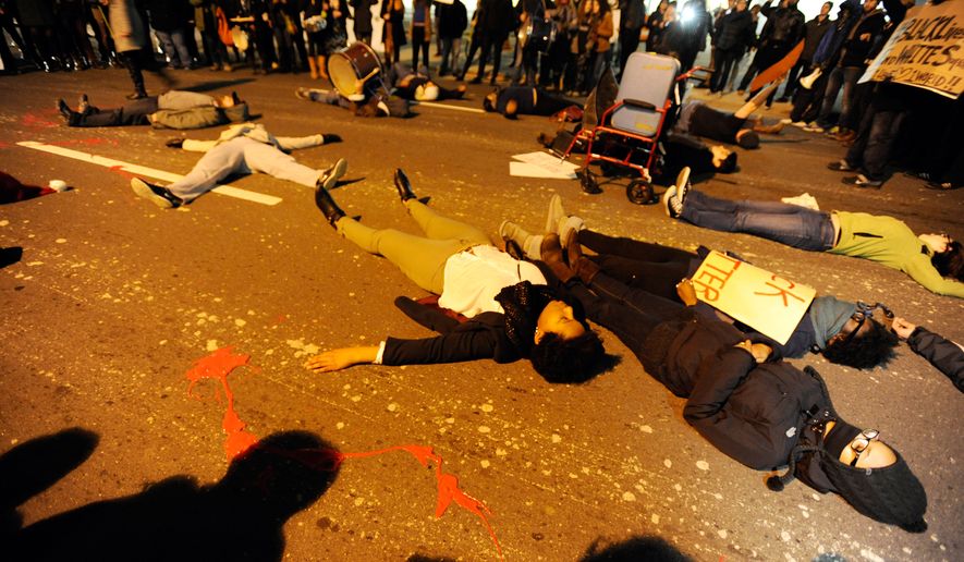 Protestors stage a &quot;die-in&quot; in downtown Durham, N.C., on Dec. 5, 2014, during a demonstration against the non-indictments of the police officers involved in the deaths of Michael Brown in Ferguson, Missouri, and Eric Garner in New York City. (Associated Press/The Herald-Sun, Christine T. Nguyen) **FILE**