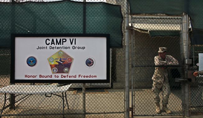 A soldier stands guard at the front gate entrance to Guantanamo&#x27;s Camp 6 maximum-security detention facility at Guantanamo Bay U.S. Naval Base in Cuba on May 12, 2009. (Associated Press) **FILE**
