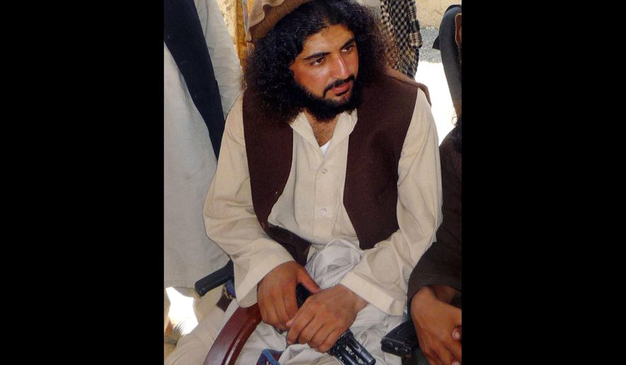 FILE - In this Oct. 4, 2009 file photo, Pakistani Taliban commander Latif Mehsud sits with fellows in Sararogha in south Waziristan in Pakistan. The U.S. military in Afghanistan has handed over three Pakistani detainees to Islamabad, including one who Pakistani intelligence officers said is a senior Taliban commander long wanted by the Pakistani government. The transfer of Mehsud, a close confidante of the former head of the Pakistani Taliban, underlines the improving relations between the U.S., Pakistan and Afghanistan.  (AP Photo/Ishtiaq Mahsud, File)
