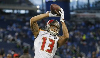 Tampa Bay Buccaneers wide receiver Mike Evans (13) runs through pre-game drills before an NFL football game against the Detroit Lions in Detroit, Sunday, Dec. 7, 2014. (AP Photo/Paul Sancya)