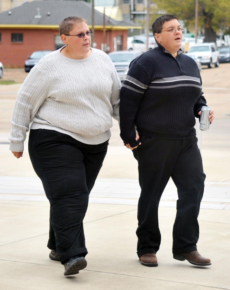 FILE -In this Nov. 12, 2014 file photo, plaintiffs Rebecca Bickett, right, and her partner, Andrea Sanders, arrive at the federal courthouse to challenge the state's out right ban on gay marriage, in Jackson, Miss. An attorney is again asking a federal appeals court to let same-sex marriages start in Mississippi. Roberta Kaplan represents a gay-rights group and partners Bickett and Sanders as well as another lesbian couples in challenging Mississippi’s legal definition of marriage as only between a man and a woman. (AP Photo/The Clarion-Ledger, Greg Jenson, File)