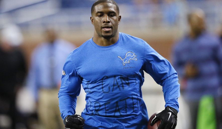 Wearing a Detroit Lions shirt with &quot;I can&#39;t breathe&quot; written on the front, running back Reggie Bush runs through pregame warmups in an NFL football game against the Tampa Bay Buccaneers in Detroit on Sunday. (AP Photo/Rick Osentoski)